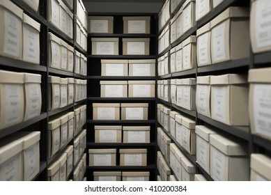 Archive evidence police depository cardboard box black shelves with white office boxes card file