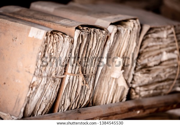 Archive of historical documents bound in files.\
Old paper documents in the archive. Enhancement of archival\
documents. Concept of discovery of the\
past.