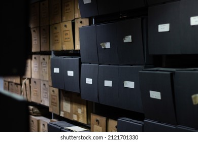 Archives Files Boxes On A Shelf. Research Or Investigation Background. Old Archives Room With Brown And Dark Boxes