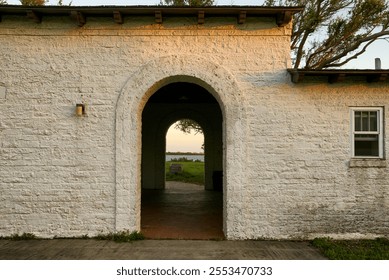 The archway of the rustic building frames a stunning outdoor lan