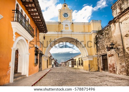 Arco de Santa Catalina and colonial houses in tha street view of Antigua, Guatemala.  The historic city Antigua is UNESCO World Heritage Site since 1979.