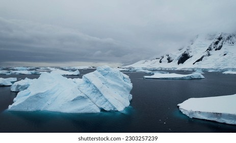 Arctic, Antarctica, Drone, Fly Over, Beach, Polar Region, Climate Change, Global Warming, Landscape, Mountain Range, Ocean, Ice, Icebergs, Tourists, Tourism, Science Station, Travel, Adventure. 