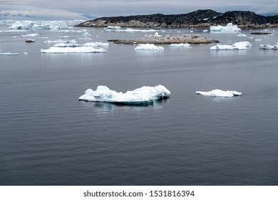 Arctic Icebergs Greenland In The Arctic Sea. You Can Easily See That Iceberg Is Over The Water Surface  And Below The Water Surface. Sometimes Unbelievable That 90% Of An Iceberg Is Under Water 