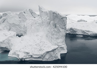 Arctic Icebergs Greenland In The Arctic Sea. You Can Easily See That Iceberg Is Over The Water Surface, And Below The Water Surface. Sometimes Unbelievable That 90% Of An Iceberg Is Under Water