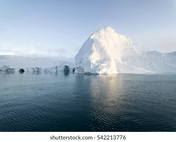 Arctic Icebergs Greenland In The Arctic Sea. You Can Easily See That Iceberg Is Over The Water Surface, And Below The Water Surface. Sometimes Unbelievable That 90% Of An Iceberg Is Under Water