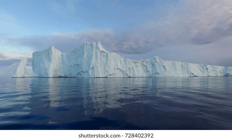 Arctic Icebergs Greenland In The Arctic Sea. You Can Easily See That Iceberg Is Over The Water Surface, And Below The Water Surface. Sometimes Unbelievable That 90% Of An Iceberg Is Under Water.