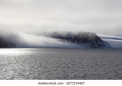 Arctic Island With Glacier Covered With Fog