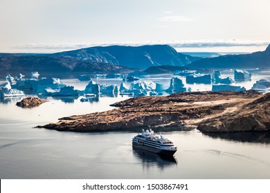 Arctic landscape, top view on icebergs , mountains and expedition cruise ship, Umanaq Bay, Greenland