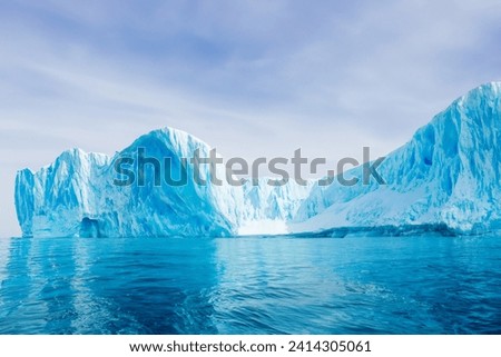 Arctic Splendor: Majestic Ice Cliffs Embrace a Cool Atmosphere, Framed by Beautiful Sea and Sky, Creating an Icy Wonderland Where Polar Majesty and Celestial Serenity Converge