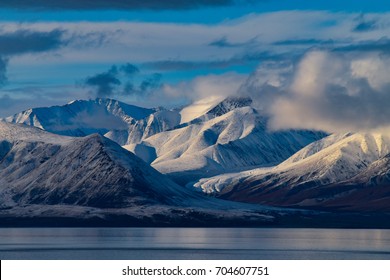 Arctic sunset near Pond Inlet, Canada - Shutterstock ID 704607751