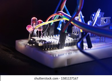 Arduino nano breadboard in beam light prototyping board transistors resistors LEDs red and blue in Shine in the dark on black skin