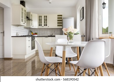 Area Of Dining Room With Table And View Of The Bright Open Plan Kitchen