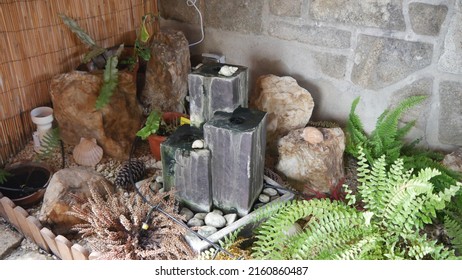 An Area Of ​​indoor Garden Decorations, With A Small Fountain, Plants And Pebbles, Exotic Decor