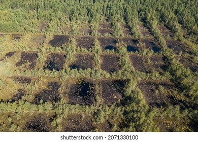 Areal View Of Bog Where Peat Was Once Extracted. Panes That Look Like Checkers Or A Chess Board.