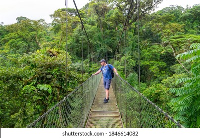 Arenal Hanging Bridges, Man Hiking In Green Tropical Jungle, Costa Rica, Central America.