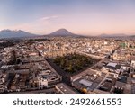 Arequipa, Peru: Aerial panoramic view of the Plaza de Armas in Arequipa colonial old town with the Basilica Cathedral and the Misti and  Chachani volcano at sunset in the Andes mountain