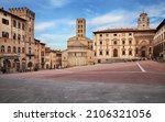 Arezzo, Tuscany, Italy: the main square Piazza Grande with the medieval church and buildings, in the old town of the ancient Italian city of art 