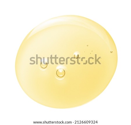 Argan oil serum gel drop texture. Yellow cosmetic liquid with bubbles isolated on white background. Skincare beauty product swatch macro