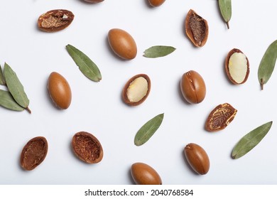 Argan seeds isolated on a white background. Argan oil nuts with plant. Cosmetics and natural oils background 