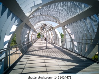 The Arganzuela Footbridge. It Is A Modern Metal Bridge Outdoors Located In The Madrid Rio Green Park Near Madrid Beach And Across The Manzanares River