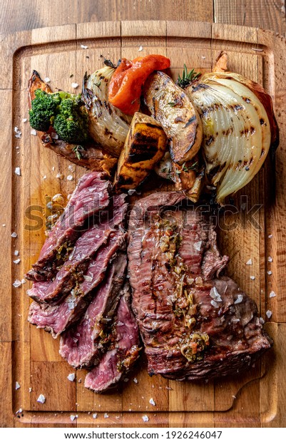 Argentine cut of meat called Vacio with\
chorizos and\
chimichurri.