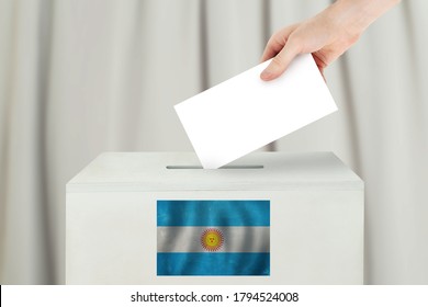 Argentinean Vote concept. Voter hand holding ballot paper for election vote on polling station