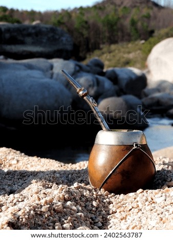 Argentinian mate facing the river and mountains