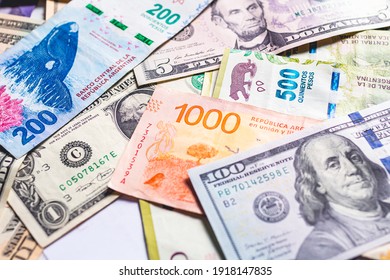 Argentininan Pesos. Money Notes Of The Argetina's Currency And A US Dollar Bills To Represent The Foreign Exchange Theme.