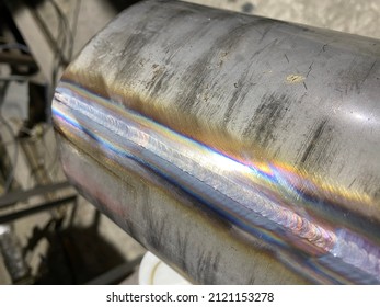 Argon welding on metal structures. Welding seams on pipes. Welding work at the factory.  Welding on stainless steel. Factory construction.