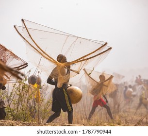 Argungu, Kebbi State, Nigeria - March 14 2020: A Fisherman Carrying His Net And A Calabash After The Days Job. 