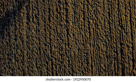 Arial Drone View Of Freshly Plowed Field Ready For Seeding And Planting In Spring.  Farmland. Empty Plowed Farm Land Prepared For The New Crop. Agriculture. Brown Black Soil Near Village.