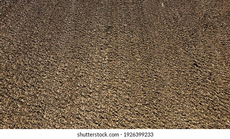 Arial Drone View Of Freshly Plowed Field Ready For Seeding And Planting In Spring.  Farmland. Empty Plowed Farm Land Prepared For The New Crop. Agriculture. Brown Black Soil Near Village.