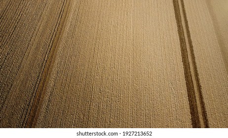 Arial Drone View Of Freshly Plowed Field Ready For Seeding And Planting In Spring.  Farmland. Empty Plowed Farm Land Prepared For The New Crop. Agriculture. Brown Black Soil Near Village.