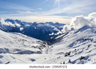 Arial Shot Of A Mountain Landscape In Winter In The Ski Resort Of La Plagne In The French Alps On A Sunny Day. 