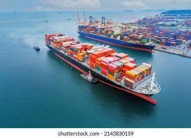 Arial view by drone camera transportation logistics and container dock cargo yard with working crane bridge in shipyard with transport logistic import export with blue sky background.