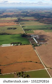 Arial View Of Farm Fields On A Sunny Fall Day Near Hanover Ontario Canada With Wind Turbines Off In The Distance