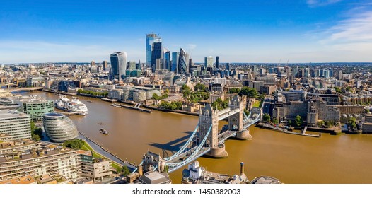 Arial View Of London With The River Thames Floating Through The City Near The Tower Bridge, London City And Westminster Abbey.