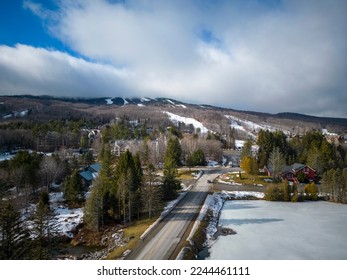 Arial view of Mount Snow ski resort mountain with clouds covering the top of the mountain. - Shutterstock ID 2244461111