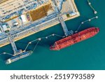 Arial view of  Oil Chemical tanker ship loading and uploading oil and lpg,NGV gas at industrial estate over open sea at seaport Thailand. Oversea transportation, Import-Export Business and Logistic.