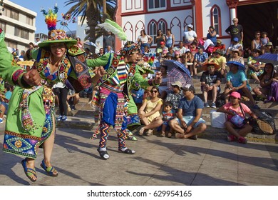 ARICA, CHILE - FEBRUARY 11, 2017: Tinkus dancers dressed in ornate costumes performing during a street parade at the annual Carnaval Andino con la Fuerza del Sol in Arica, northern Chile.