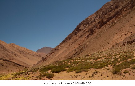 The Arid Desert High In The Andes Mountains. View Of The V Shape Valley, Brown Mountains And Sand In La Rioja, Argentina. 