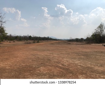 An arid open field and a cloudy sky background