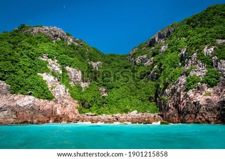 Aride island nature reserve view from the Indian Ocean with blue sky. Praslin, Seychelles