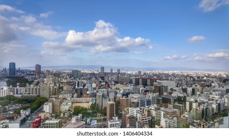 Ariel City View With Blue Sky And Some Clouds Are Above The Buildings