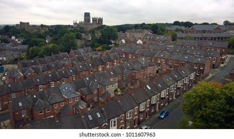 ariel view of the city of durham showing streets of old brick houses the cathedral and castle with trees on the skyline