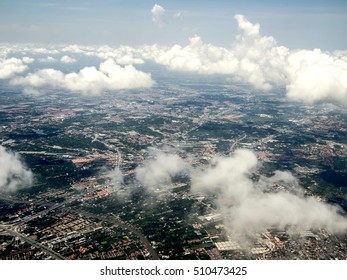 Ariel View Of The City And River Through The Clouds