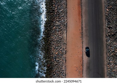 Ariel view of Dhanushkodi beach with a car moving on the road.