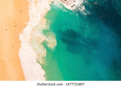 Ariel View On Beach And Waves With People At Manta Bay Or Kelingking Beach On Nusa Penida Island,Bali,Indonesia 