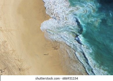 Ariel View On Beach With Waves And People At Karang Dawa, Manta Bay Or Kelingking Beach On Nusa Penida Island, Bali, Indonesia