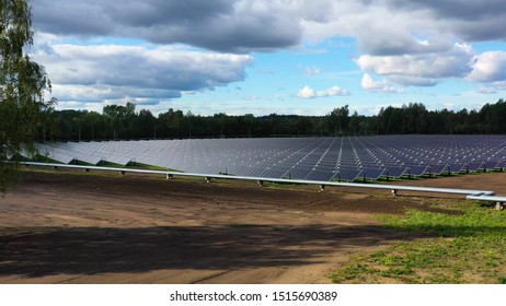 Ariel View , Shot From A Drone On A Farm Field There Are A Lot Of Solar Panels That Produce Environmental Energy. 